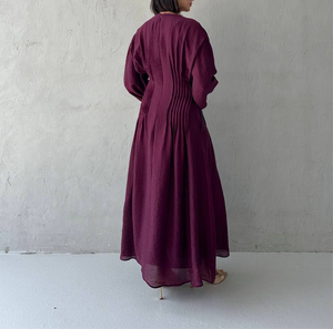Flowy long sleeve pleated dress in plum purpl